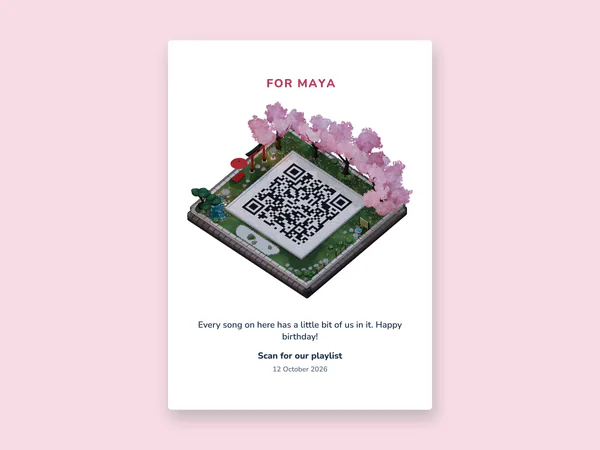 A printed gift card reading For Maya above the Sakura Night island, whose courtyard is a QR code, with a birthday message and the line Scan for our playlist